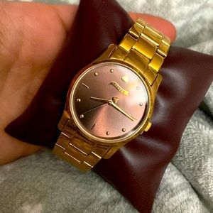 A Hershey Kiss Watch with a light purple/brown watch face NWT